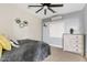 Serene bedroom featuring soft blue walls, a ceiling fan, and cozy decor at 21921 E Domingo Rd, Queen Creek, AZ 85142