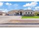 Inviting home exterior featuring manicured lawn and stone accents enhancing its curb appeal at 21921 E Domingo Rd, Queen Creek, AZ 85142