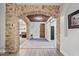 Beautiful foyer featuring stone archway, wood ceiling, and inviting doorway at 21921 E Domingo Rd, Queen Creek, AZ 85142