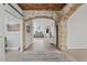 Elegant hallway with stone archway and views of the living spaces at 21921 E Domingo Rd, Queen Creek, AZ 85142