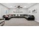 Comfortable living room with a large sectional sofa, fan, and neutral color palette at 21921 E Domingo Rd, Queen Creek, AZ 85142