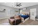 Comfortable main bedroom with a plush chair, ceiling fan, and bright window at 21921 E Domingo Rd, Queen Creek, AZ 85142