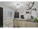 Bright home office with a built-in desk and a ceiling fan at 21921 E Domingo Rd, Queen Creek, AZ 85142