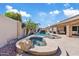 Backyard pool and spa area with rock features and a rock waterfall at 21921 E Domingo Rd, Queen Creek, AZ 85142