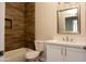 Cozy bathroom featuring a bathtub, shower, wood tile and a vanity with quartz countertops and chrome fixtures at 26409 W Desert Crest St, Casa Grande, AZ 85193