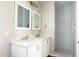 Bright bathroom featuring a double vanity with quartz countertops and a walk-in shower with glass door at 26409 W Desert Crest St, Casa Grande, AZ 85193