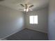 Comfortable bedroom with plush carpet, a ceiling fan, and a window offering natural light at 26409 W Desert Crest St, Casa Grande, AZ 85193