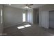 Bright bedroom featuring plush carpet, a ceiling fan, closet and a door to the exterior at 26409 W Desert Crest St, Casa Grande, AZ 85193