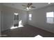 Bright bedroom with carpet, ceiling fan, and access to the en suite bathroom at 26409 W Desert Crest St, Casa Grande, AZ 85193