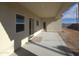 View of a covered patio with neutral concrete and easy access through doors and windows at 26409 W Desert Crest St, Casa Grande, AZ 85193