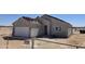 View of a new build with an unfinished roof, a white garage door and surrounded by fencing at 26409 W Desert Crest St, Casa Grande, AZ 85193