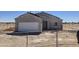 Exterior view of a single story home with an unfinished roof and an attached white garage at 26409 W Desert Crest St, Casa Grande, AZ 85193