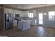 Modern kitchen featuring stainless steel appliances, white cabinets, and a center island with pendant lighting at 26409 W Desert Crest St, Casa Grande, AZ 85193