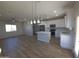 Open-concept kitchen featuring an island, stainless appliances, and white cabinetry at 26409 W Desert Crest St, Casa Grande, AZ 85193