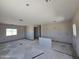 Spacious living room with newly painted walls, bare floors and natural light from the window at 26409 W Desert Crest St, Casa Grande, AZ 85193