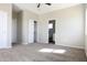 Spacious bedroom featuring plush carpet, a ceiling fan, an ensuite bath, and a walk-in closet at 26409 W Desert Crest St, Casa Grande, AZ 85193