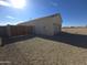 Exterior side view of a home with a gated yard, block fencing, and two-car garage at 26409 W Desert Crest St, Casa Grande, AZ 85193