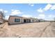 Rear exterior view of the house with desert landscaping and a covered patio at 26664 W Siesta Ln, Buckeye, AZ 85396