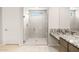 Contemporary bathroom featuring a tiled shower with glass door, granite countertops, and stylish vanity at 26664 W Siesta Ln, Buckeye, AZ 85396