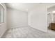 Neutral bedroom with carpet floors, natural light, and an ensuite bathroom at 26664 W Siesta Ln, Buckeye, AZ 85396