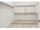 Walk-in closet with neutral carpet, ample shelving, and rod space for organized storage at 26664 W Siesta Ln, Buckeye, AZ 85396