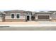 Charming home exterior features desert landscaping, a two-car garage, and a tile roof at 26664 W Siesta Ln, Buckeye, AZ 85396