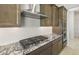 Kitchen features granite countertops, stainless KitchenAid hood vent, and a gas cooktop at 26664 W Siesta Ln, Buckeye, AZ 85396