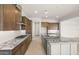 Modern kitchen featuring a spacious island with granite countertops and stainless steel appliances at 26664 W Siesta Ln, Buckeye, AZ 85396