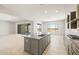 Open concept kitchen with a large island, gas cooktop, and view to the patio at 26664 W Siesta Ln, Buckeye, AZ 85396