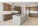 Modern kitchen with gray island, stainless appliances, and beautiful countertops at 26664 W Siesta Ln, Buckeye, AZ 85396