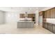 Gourmet kitchen with stainless appliances, kitchen island, and modern backsplash at 26664 W Siesta Ln, Buckeye, AZ 85396