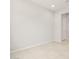 Spacious living room features neutral tones, recessed lighting, and tile flooring at 26664 W Siesta Ln, Buckeye, AZ 85396