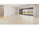 Open living space with tile flooring, neutral tones, and a sliding glass door at 26664 W Siesta Ln, Buckeye, AZ 85396