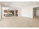 Open living area with tile floors, natural light, and access to kitchen at 26664 W Siesta Ln, Buckeye, AZ 85396
