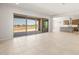 Open living room features a large sliding glass door that opens to the backyard at 26664 W Siesta Ln, Buckeye, AZ 85396
