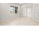 Bright office space with neutral tones and tile flooring features modern french doors at 26664 W Siesta Ln, Buckeye, AZ 85396
