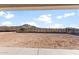 An expansive backyard with a serene desert mountain view beyond the wrought iron fence at 26903 W Renee Dr, Buckeye, AZ 85396