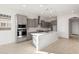 Bright kitchen with gray cabinets, stainless steel appliances, and a large center island at 26903 W Renee Dr, Buckeye, AZ 85396