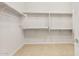 Bright walk-in closet featuring white shelving and ample storage space at 26903 W Renee Dr, Buckeye, AZ 85396