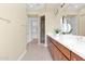 Neutral bathroom featuring a double vanity, large mirror, and glass-enclosed shower at 27000 N Alma School Pkwy # 1032, Scottsdale, AZ 85262