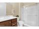 Bright bathroom boasts a stylish vanity with cherry cabinets and a glass-enclosed shower at 27000 N Alma School Pkwy # 1032, Scottsdale, AZ 85262