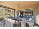 Inviting covered patio with comfortable seating and a view into the open-concept kitchen and living area at 27000 N Alma School Pkwy # 1032, Scottsdale, AZ 85262