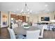 Modern dining area connected to kitchen and living spaces, featuring stylish lighting and comfortable seating at 27000 N Alma School Pkwy # 1032, Scottsdale, AZ 85262