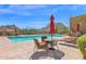 Community pool area showcasing clear blue water, comfortable lounge chairs, and picturesque mountain views at 27000 N Alma School Pkwy # 1032, Scottsdale, AZ 85262