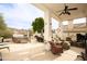 Covered patio with outdoor furniture, ceiling fan, spa, and outdoor fireplace at 301 E Ashurst Dr, Phoenix, AZ 85048