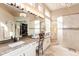 Elegant bathroom with double sinks, granite counters, and a mosaic tile design at 301 E Ashurst Dr, Phoenix, AZ 85048