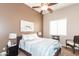 Relaxing bedroom featuring ceiling fan, soft lighting, and comfortable furnishings at 301 E Ashurst Dr, Phoenix, AZ 85048