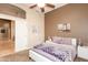 Bedroom with decorative paintings, ceiling fan, and sliding doors to the hallway at 301 E Ashurst Dr, Phoenix, AZ 85048