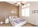 Bedroom with white furniture, ceiling fan, and views of the home exterior at 301 E Ashurst Dr, Phoenix, AZ 85048