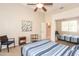 Well-lit bedroom with ceiling fan, mirrored closet, and neutral wall color at 301 E Ashurst Dr, Phoenix, AZ 85048